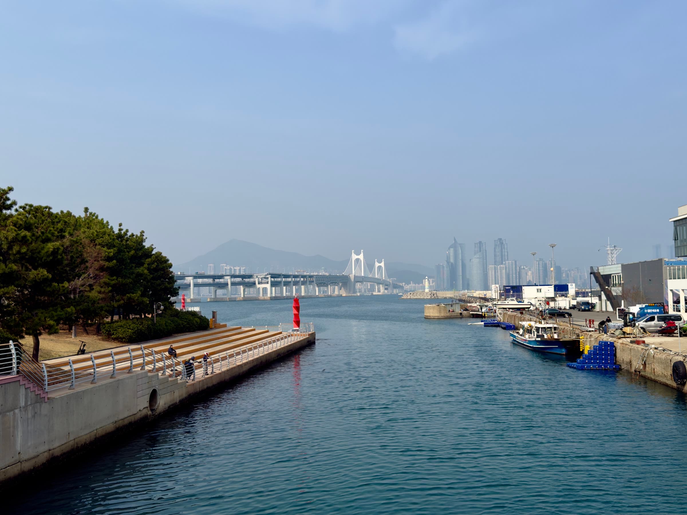 A harbour with a suspension bridge and city skyline in Korea